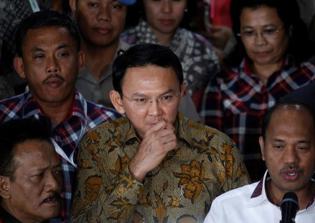 Jakarta governor who is charged with blasphemy asks supporters to pray for a fair trial